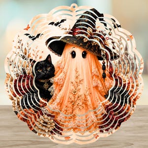May include: A circular wind spinner featuring a printed design of a ghost wearing a black witch hat and a black cat with a gold collar. The scene includes autumn leaves, flowers, and bats, all framed by a scalloped, laser-cut metal edge.
