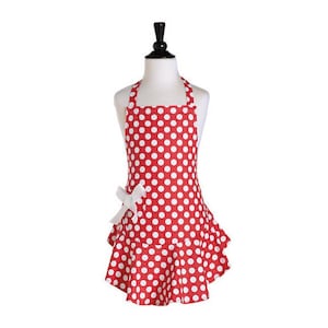 May include: Red and white polka dot apron with a white bow and a ruffled hem.