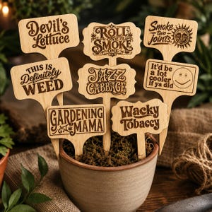 May include: A collection of eight light-colored wooden plant markers with laser-engraved text including Devil's Lettuce, Roll One Smoke One, Smoke Two Joints, This Is Definitely Weed, Jazz Cabbage, It'd be a lot cooler if ya did, Gardening Mama, and Wacky Tobaccy.