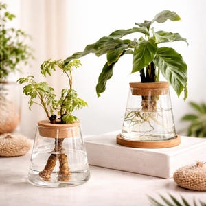 May include: A set of three ceramic mugs with a speckled, matte finish in cream, light grey, and dark grey. Each mug has a simple, minimalist design and a rounded handle. The mugs are stacked on top of each other.