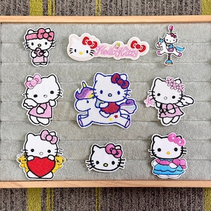 May include: A white ceramic mug with a black handle and the text "But First, Coffee" in a black, bold font. The mug is on a white surface.