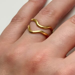 May include: A rustic wooden sign with the text "Welcome to our home" in white lettering. The sign features a distressed finish and a simple, inviting design, perfect for entryway decor.