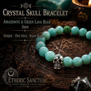 Puede incluir: Pulsera con cuentas redondas y lisas de amazonita verde claro, una cuenta de lava verde texturizada y un dije de calavera de metal plateado. Las cuentas miden 8mm de diámetro. Texto: CRYSTAL SKULL BRACELET, AMAZONITE & GREEN LAVA BEAD, 8MM, UNIQUE - ONE PIECE - HAND MADE, ETHERIC SANCTUM, OCCULT APOTHECARY & RITUAL SUPPLIES.