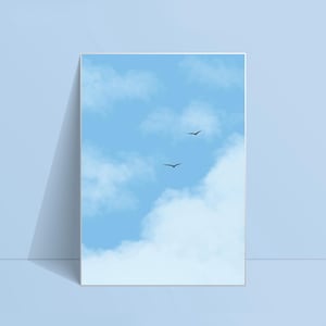 May include: A framed art print showing a light blue sky with white clouds and two dark birds in flight. The artwork is displayed against a light blue background. The print evokes a sense of calm and tranquility.