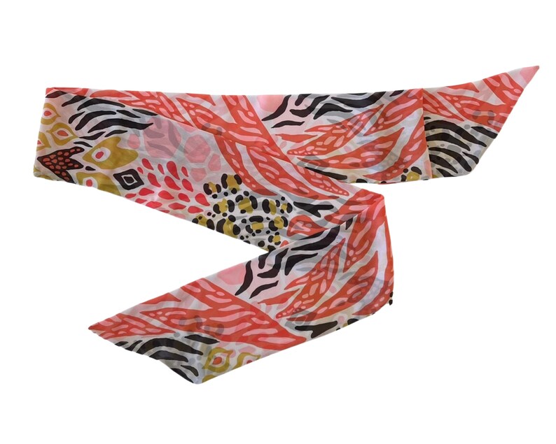 May include: A pink, black, and gold patterned scarf with a zebra print and floral design.
