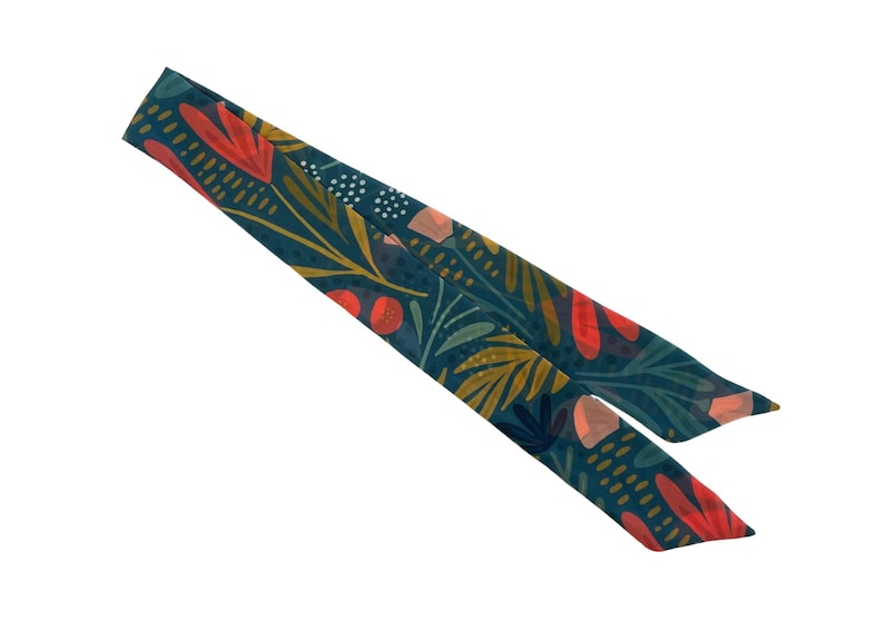 May include: A teal blue fabric scarf with a floral pattern featuring red, orange, and yellow flowers and leaves.