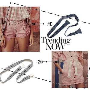 May include: Two women wearing denim shorts and a denim skirt with woven belts. The belts are tied with tassels and feature geometric patterns. The text "Trending Now" is visible in the image.