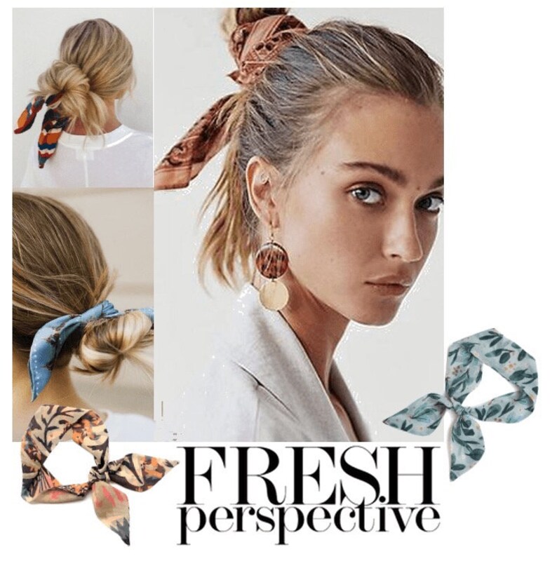 May include: Four different floral patterned silk scarves tied in a bow. The scarves are in shades of blue, green, orange, and brown. The scarves are shown tied around a woman's hair in a bun.