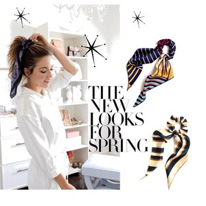 May include: Two colorful patterned hair scrunchies with a bow. The scrunchies are made of silk and have a striped pattern. The text "THE NEW LOOKS FOR SPRING" is visible in the background.