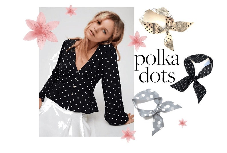 May include: A black and white polka dot blouse with long sleeves and a V-neckline. The blouse has a fitted bodice and a slightly flared hem. The model is wearing the blouse with a white skirt. The image also includes three polka dot headbands in different colors: black and white, gray and white, and beige and black.