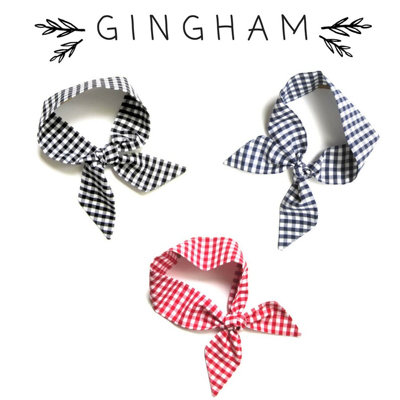 May include: Three gingham fabric headbands in black and white, navy and white, and red and white.