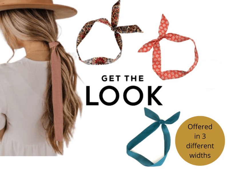 May include: Three fabric headbands in different patterns and colours. The headband on the left is a paisley pattern in shades of red, brown, and white. The headband in the middle is a red headband with a white snowflake pattern. The headband on the right is a solid teal blue. The text "GET THE LOOK" is in the centre of the image. The text "Offered in 3 different widths" is in the bottom right corner of the image.