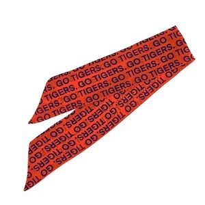 May include: Orange and navy blue head scarf with the text "GO TIGERS" repeated across the fabric. The scarf is tied in a knot, with the ends pointing towards the bottom left and top right corners.