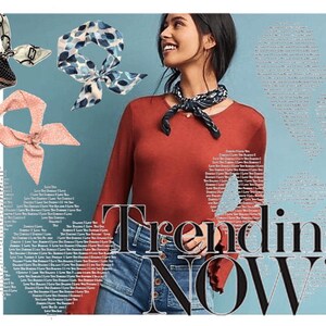 May include: A woman wearing a red long-sleeved shirt, blue jeans, and a black and white patterned bandana. The text "Trending NOW" is in large black letters on a light blue background.