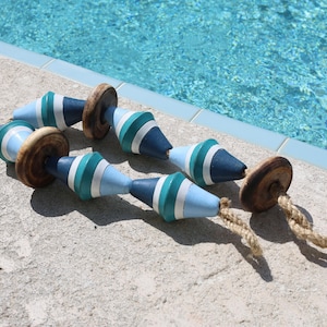 May include: A blue and green striped rope with wooden beads, perfect for nautical themed decor.