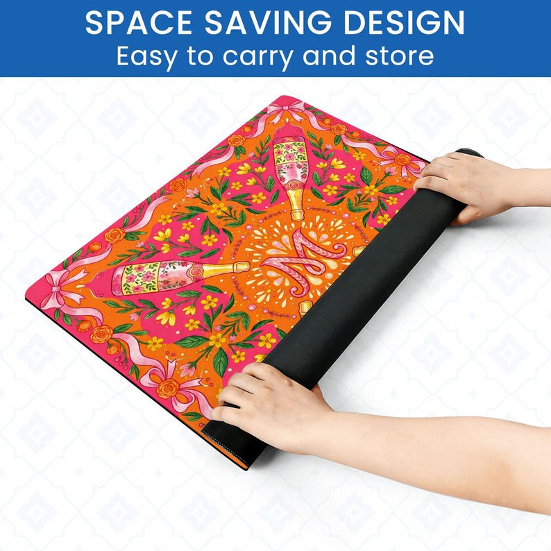 May include: A colorful yoga mat with a champagne bottle design. The mat features a vibrant orange and pink floral pattern with champagne bottles and ribbons. The text "SPACE SAVING DESIGN Easy to carry and store" is at the top.