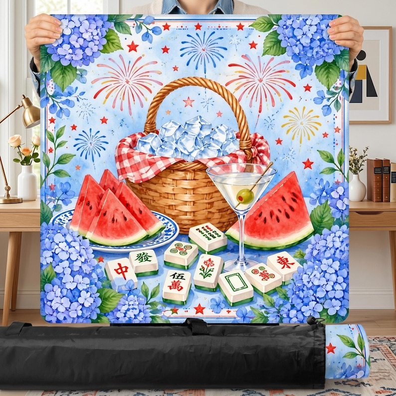 May include: A picnic blanket with a watercolor design featuring a picnic basket filled with ice, watermelon slices, a martini, and Mahjong tiles. The background includes fireworks, blue hydrangeas, and red stars.