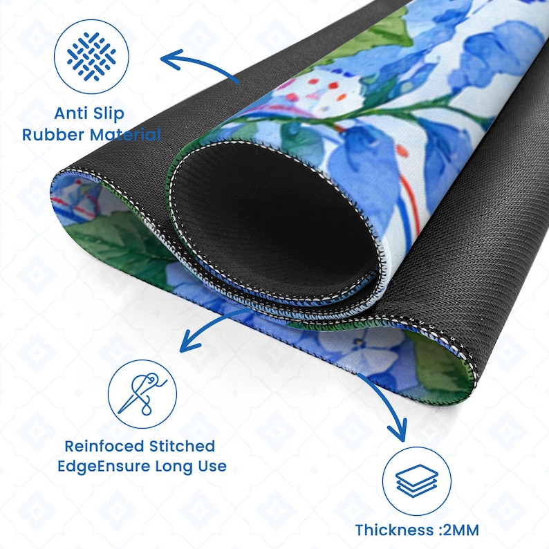 May include: A rolled-up mousepad with a floral design featuring blue and white flowers. The mousepad has a black, anti-slip rubber base and reinforced stitched edges. The thickness is 2mm.