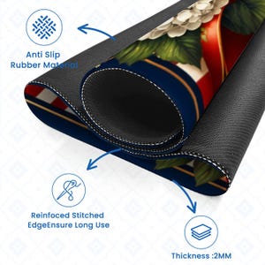May include: A rolled-up mousepad with a floral design, featuring white flowers, red stripes, and a blue background. The mousepad has a black, anti-slip rubber base and reinforced stitched edges. The thickness is 2mm.