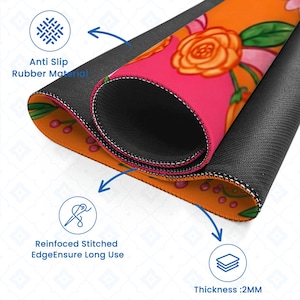 May include: Rolled-up mousepad with a floral design featuring orange roses and pink accents. The mousepad has a black anti-slip rubber base and reinforced stitched edges. The thickness is 2mm.