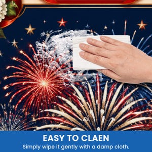 May include: A blue surface with a fireworks design, red and white bursts, and gold stars. A hand wipes the surface with a white cloth, creating suds. Text at the bottom reads "EASY TO CLEAN" and "Simply wipe it gently with a damp cloth."
