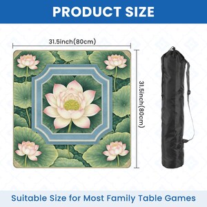 May include: A square table mat with a lotus flower design, measuring 31.5 inches (80cm) on each side. The mat features a central lotus flower surrounded by green leaves and smaller lotus flowers. A black carrying bag is shown next to the mat. The text "PRODUCT SIZE" and "Suitable Size for Most Family Table Games" are visible.