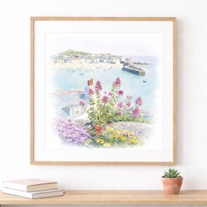 May include: Watercolor painting of a coastal town with a harbor, framed in a light wood. The artwork features a vibrant display of pink and yellow flowers in the foreground, with a town and sea in the background. A small succulent in a terracotta pot sits on a wooden shelf.