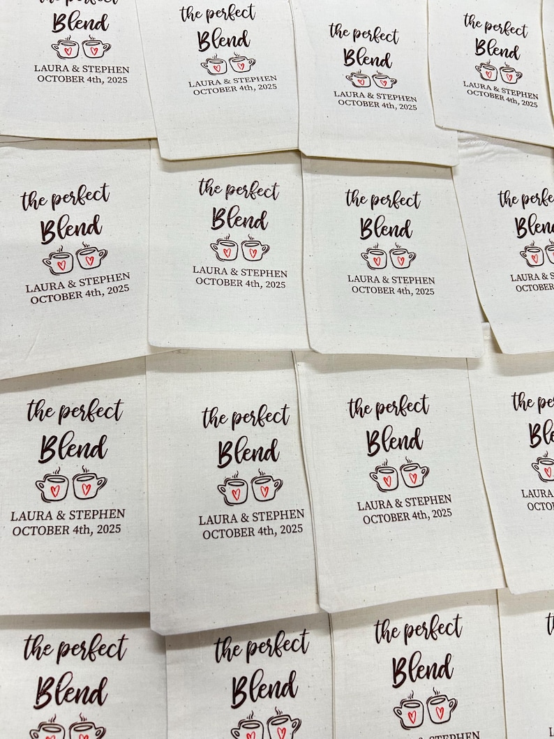May include: Off-white fabric favor bags with the text "the perfect Blend" in a script font, along with two coffee cup illustrations with hearts. The text "LAURA & STEPHEN OCTOBER 4th, 2025" is also printed on the bags.