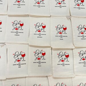 May include: Off-white canvas bags with a red wine glass and lip design. The bags have the text "Oh Sip! It's Sippin' Sisters Takeover 2025" printed on them. Each bag is personalized with a name.
