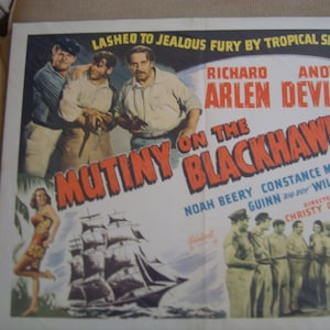 May include: A vintage movie poster for "Mutiny on the Blackhawk" featuring Richard Arlen and Andy Devine. The poster has a nautical theme with a ship illustration and a woman in a swimsuit. The title is in large, red letters.