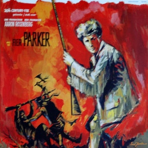 May include: A vintage movie poster for the film "Daniel Boone" with a red, orange, and yellow background. The poster features a man holding a rifle, with a group of Native Americans in the background. The text on the poster reads "Daniel Boone Sur La Piste Des Cherokess Op Het Spoor Der Cherokee's".