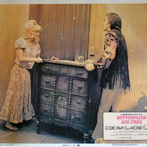May include: A movie poster for the film "Butterflies Are Free" starring Goldie Hawn, Eileen Heckart, and  E.G. Marshall. The poster features a scene from the film with Goldie Hawn and E.G. Marshall standing in a room with a dresser.
