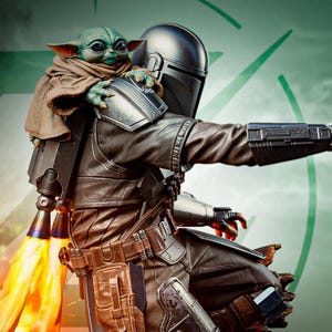 May include: A detailed figurine of The Mandalorian with Grogu. The Mandalorian is in a brown and silver suit with a helmet, and Grogu is perched on his shoulder, wrapped in a brown cloak. The figurine has a jetpack with orange flames.