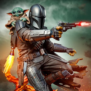 May include: A detailed figurine of The Mandalorian, clad in silver armor, aiming a blaster with a red energy beam. Grogu, the Child, sits on his shoulder. The figure is posed dynamically, with a fiery jetpack and a detailed base.