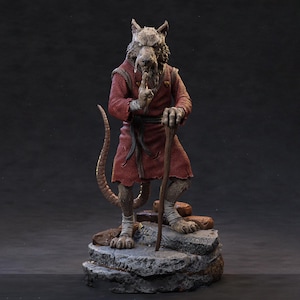 May include: A detailed figurine of a rat-like character in a red robe, holding a wooden staff. The figure stands on a rocky base, with one finger raised to its lips in a gesture of silence. The figure has a long tail.