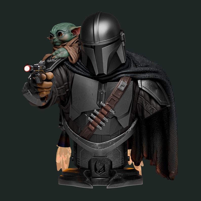 May include: A detailed bust of The Mandalorian, clad in dark gray armor and helmet, holding a blaster. Grogu, also known as Baby Yoda, is perched on his shoulder. The figure has a black cape and a brown belt with ammunition. A Star Wars collectible.