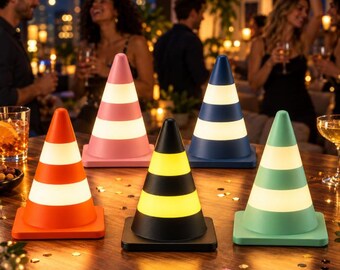 May include: Five cone-shaped lamps arranged on a table. The lamps feature horizontal stripes in orange, pink, dark blue, black, and light green, each with alternating white or yellow illuminated bands that provide a soft glow.