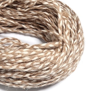 May include: A coiled length of braided twine featuring a two-tone design with alternating strands of natural tan jute and bright white cotton. The cord has a textured, rustic appearance with a consistent woven pattern throughout the entire length.