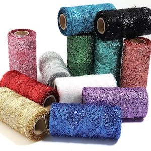 May include: A collection of twelve cylindrical spools of metallic tinsel yarn in various colours including gold, red, pink, silver, white, blue, green, teal, black, and purple. Each spool features a shiny, reflective texture and a hollow centre core.