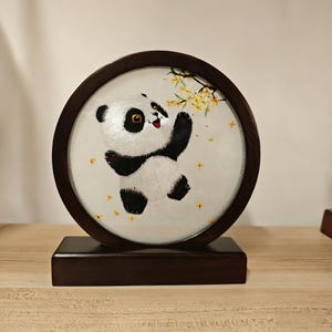 May include: A white ceramic mug with a black handle and the text "But First, Coffee" in a handwritten style. The mug is on a white surface. The mug is 4 inches tall.