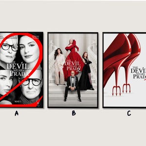 May include: Three framed movie posters for "The Devil Wears Prada 2". The first poster features Meryl Streep and Anne Hathaway. The second poster shows a group of people on a staircase. The third poster displays red high heels.