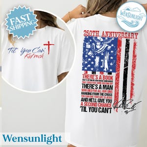 May include: White t-shirt with a patriotic design. The front features the text "Til' You Can't" and a cross. The back displays an American flag design with text that reads "250th Anniversary" and a quote. The shirt has a crew neck.