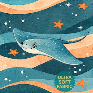 May include: Watercolor illustration of a smiling blue stingray swimming in a sea of blue and orange waves. The image includes orange starfish and white stars. Text in the lower right corner reads "ULTRA SOFT FABRIC".