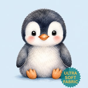 Könnte beinhalten: Eine Aquarellillustration eines niedlichen Pinguins mit blau-weißem Körper, orangefarbenen Füßen und Schnabel sowie rosigen Wangen. Der Pinguin sitzt auf hellblauem Hintergrund. Der Text "ULTRA SOFT FABRIC" befindet sich auf einem türkisfarbenen Abzeichen.