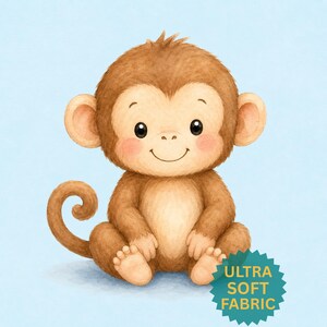 May include: A watercolor-style illustration of a brown monkey with a light tan face, chest, and feet, featuring a curled tail and pink cheeks. The monkey is sitting against a light blue background. A teal star-shaped badge reads ULTRA SOFT FABRIC.