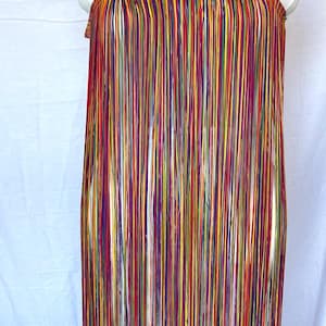 May include: A strapless tube top garment constructed entirely from long, vertical fringe strands in a vibrant multicoloured palette including red, yellow, purple, orange, and green. The top features a gathered, elasticised horizontal band.
