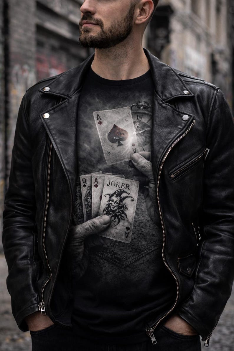 May include: Black leather jacket with a zipper closure and a black t-shirt featuring a playing card design. The t-shirt graphic includes the Ace of Spades and a Joker card. The image has a dark, moody aesthetic.