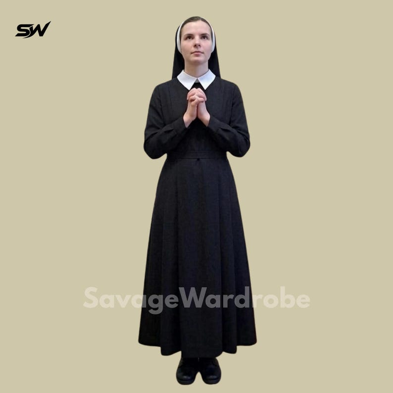 May include: A full-length black habit with a white collar and wimple. The nun's outfit includes a long-sleeved dress and a head covering. The person is standing with hands clasped in prayer. The SavageWardrobe logo is visible.