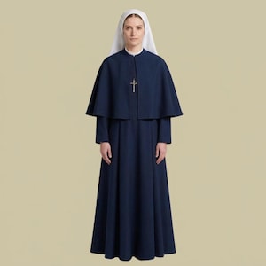 May include: A dark blue habit featuring a floor-length dress with a matching capelet, worn with a white head covering and a silver-toned crucifix pendant hanging from a chain around the neck, creating a traditional religious ensemble.