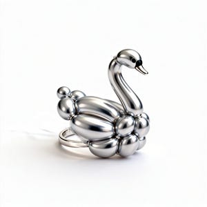 May include: A silver-colored swan ring. The ring features a swan design crafted from connected, rounded shapes, resembling balloons. The swan has a curved neck, a black eye, and a small beak. The ring band is a simple, polished silver.